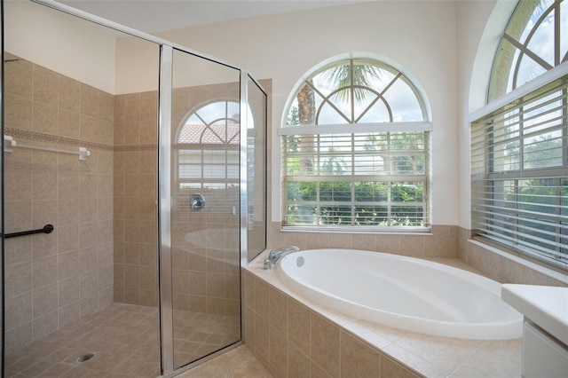 bathroom featuring shower with separate bathtub