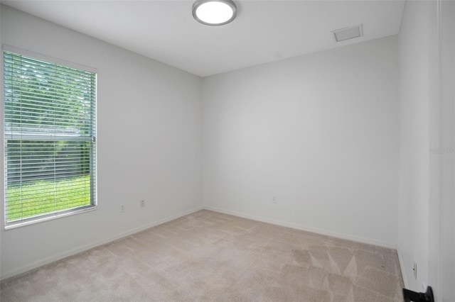 empty room featuring light carpet