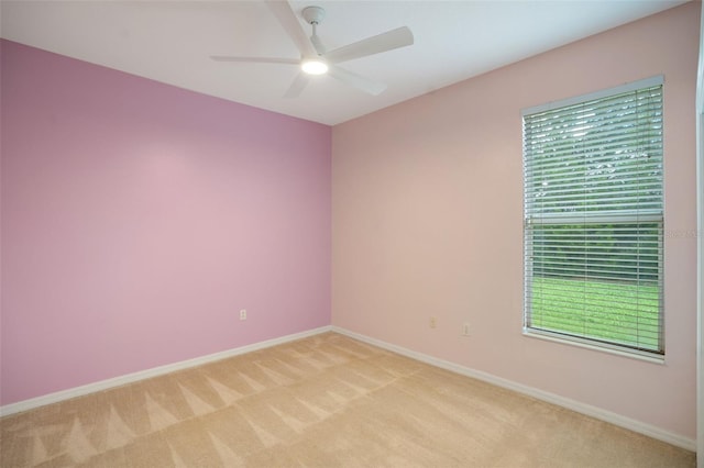 carpeted empty room featuring a healthy amount of sunlight and ceiling fan