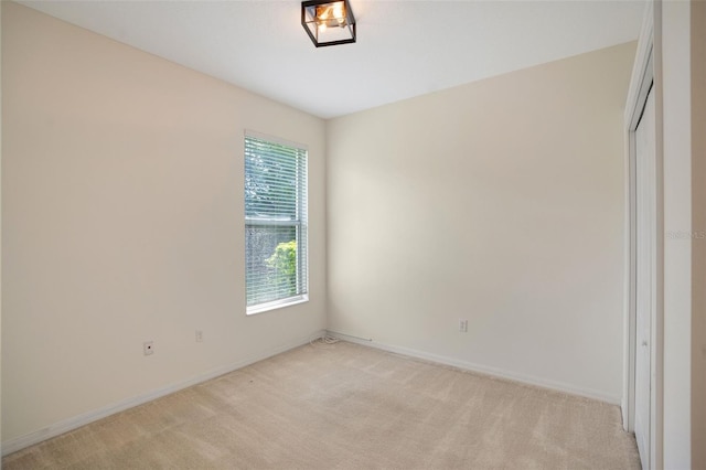 unfurnished bedroom featuring light carpet