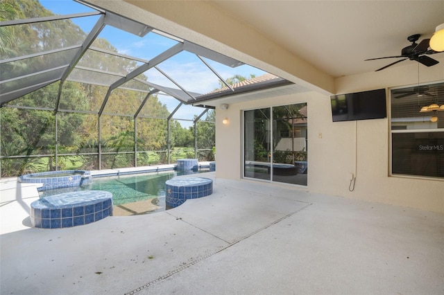 view of swimming pool featuring a lanai, an in ground hot tub, ceiling fan, and a patio