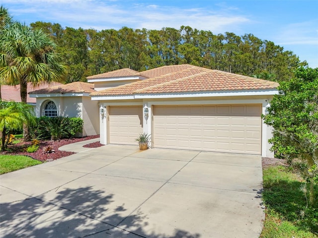 mediterranean / spanish-style home with a garage