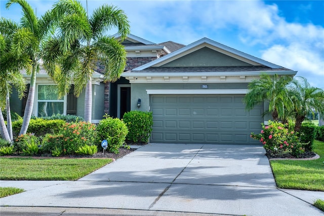 view of front of home featuring a front yard and a garage