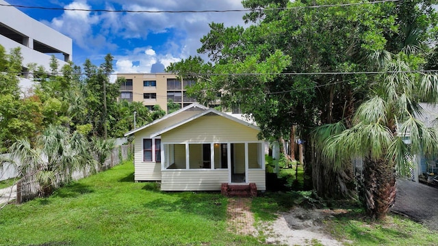 rear view of house featuring a yard