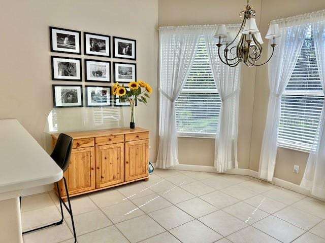 tiled dining space featuring an inviting chandelier