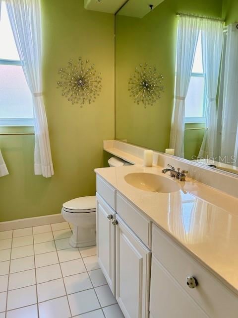 bathroom with vanity, toilet, and tile patterned flooring