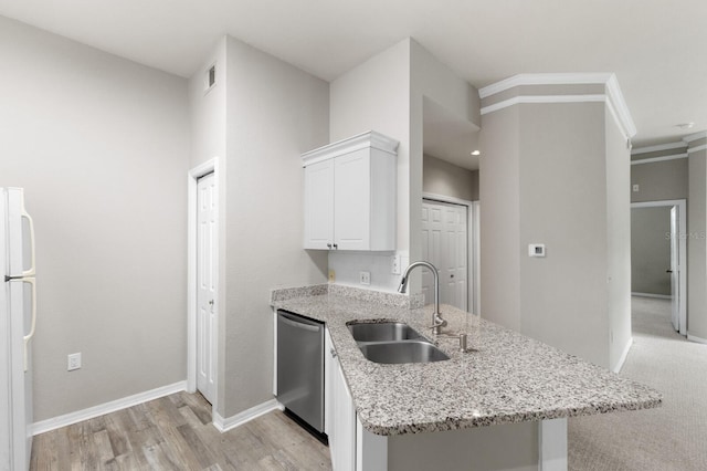 kitchen with light stone counters, sink, stainless steel dishwasher, white cabinetry, and white fridge