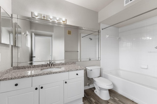 full bathroom featuring wood-type flooring, vanity, toilet, and tiled shower / bath