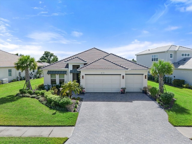 view of front of home featuring a garage and a front lawn