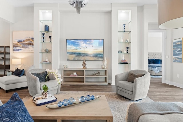 living room featuring hardwood / wood-style floors and built in features