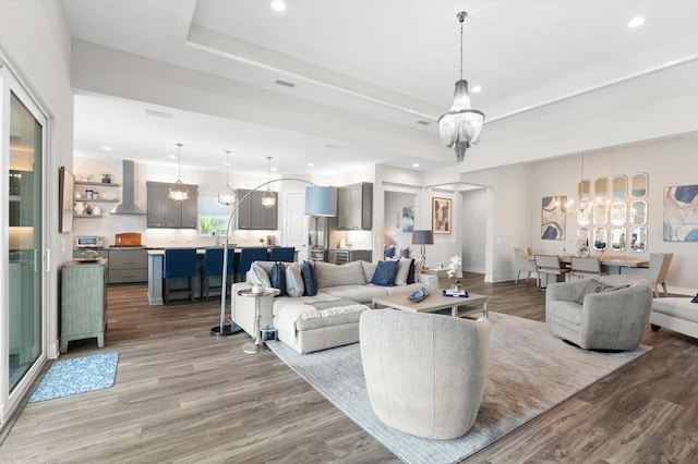 living room featuring a chandelier and light hardwood / wood-style floors