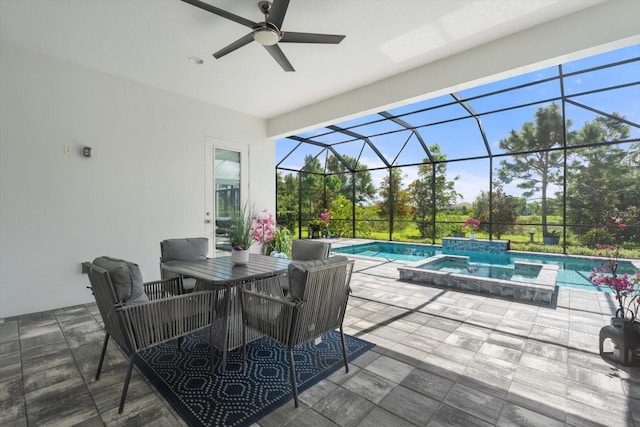 view of patio featuring glass enclosure, ceiling fan, and a swimming pool with hot tub