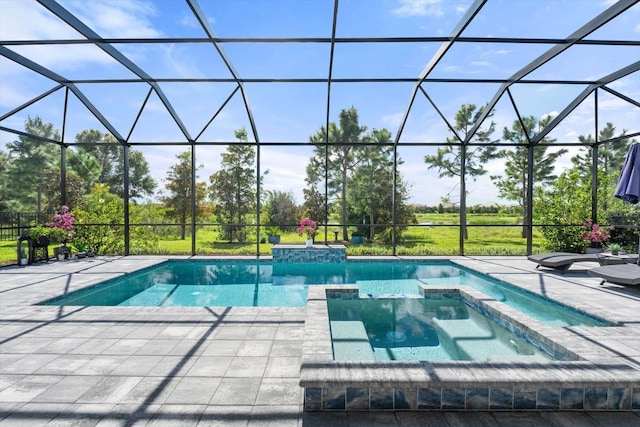 view of swimming pool featuring glass enclosure, an in ground hot tub, and a patio