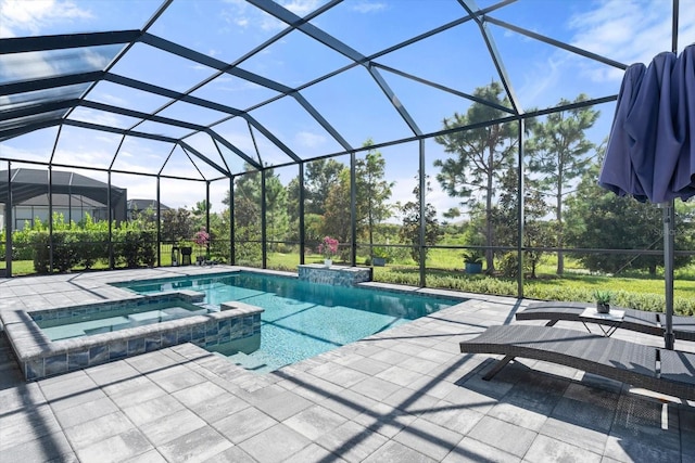 view of pool with an in ground hot tub, glass enclosure, and a patio area