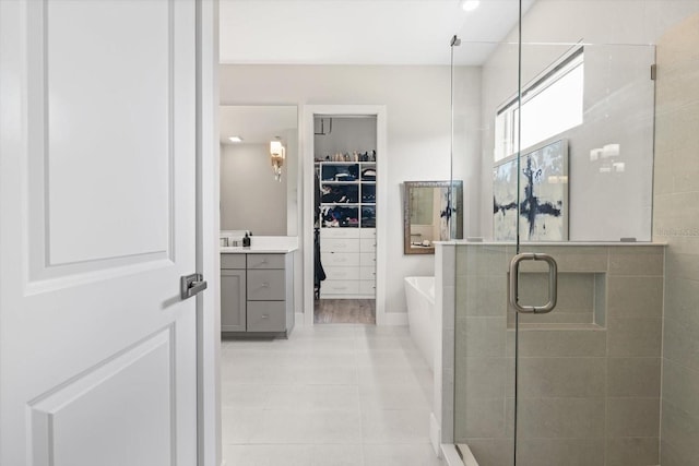 bathroom featuring vanity, tile patterned flooring, and plus walk in shower