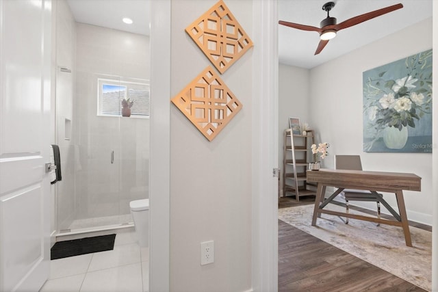 interior space with hardwood / wood-style floors, ceiling fan, toilet, and walk in shower