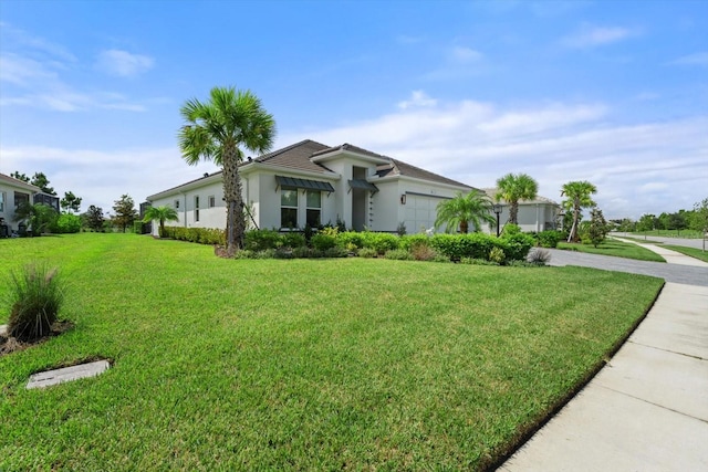 ranch-style home featuring a front yard and a garage