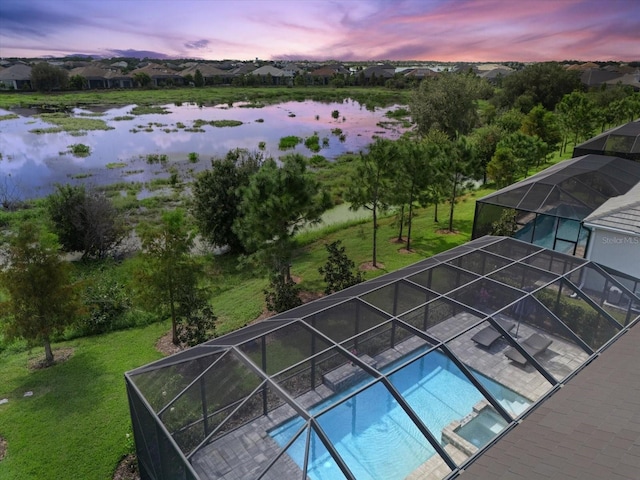 aerial view at dusk with a water view