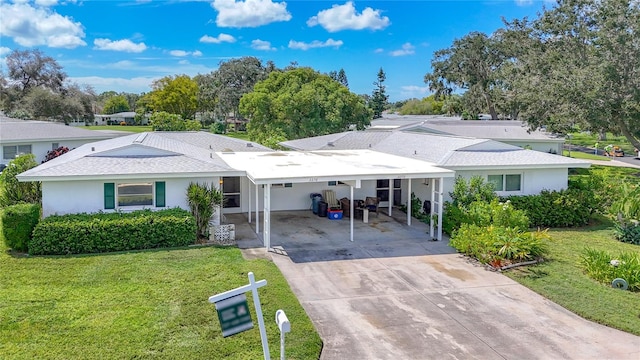 back of house featuring a yard and a carport