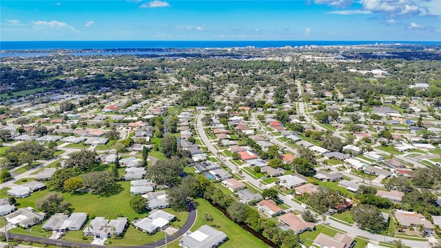 drone / aerial view featuring a residential view and a water view