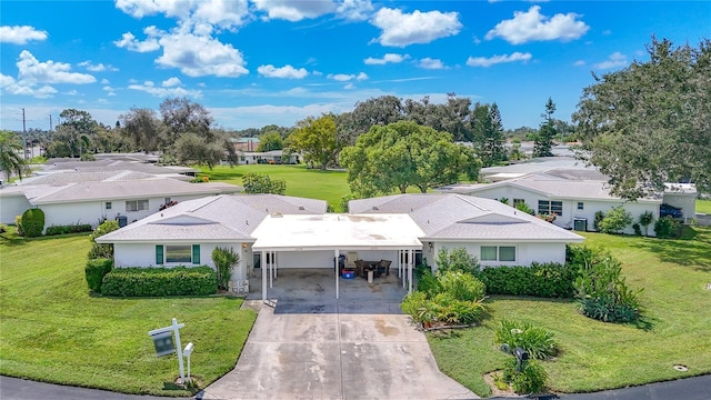 view of front of house featuring a front yard, a residential view, and concrete driveway