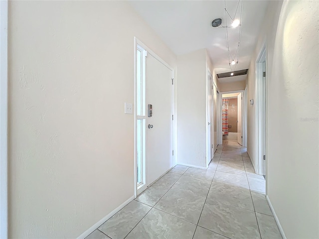 corridor with light tile patterned floors