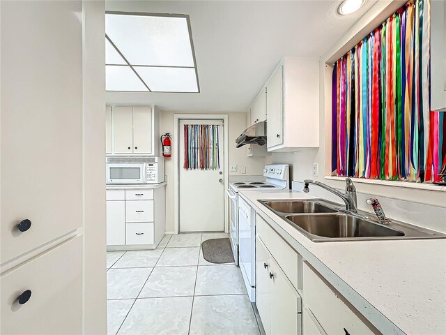 kitchen featuring a sink, light tile patterned flooring, white appliances, range hood, and light countertops