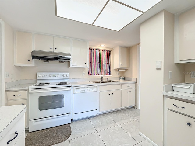 kitchen with light countertops, a sink, under cabinet range hood, and white appliances