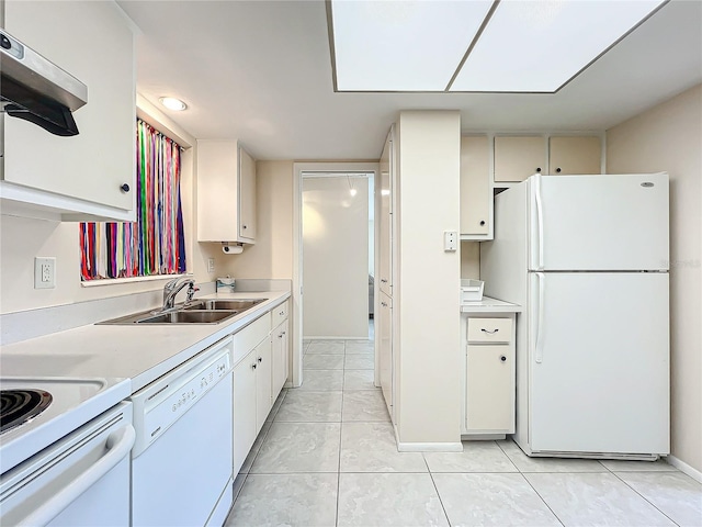 kitchen with white cabinets, a sink, white appliances, range hood, and light countertops