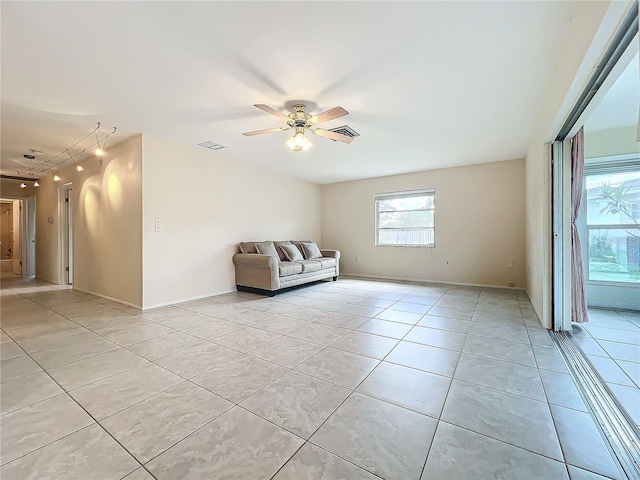 unfurnished living room with light tile patterned flooring, ceiling fan, and rail lighting