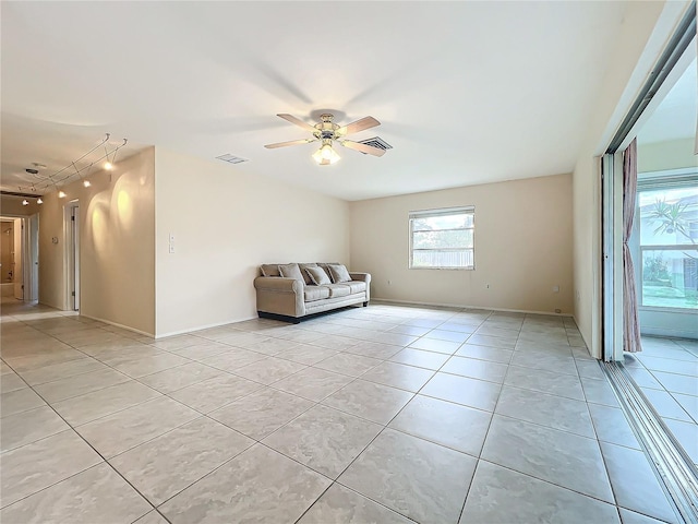 unfurnished room featuring a ceiling fan, visible vents, and light tile patterned flooring