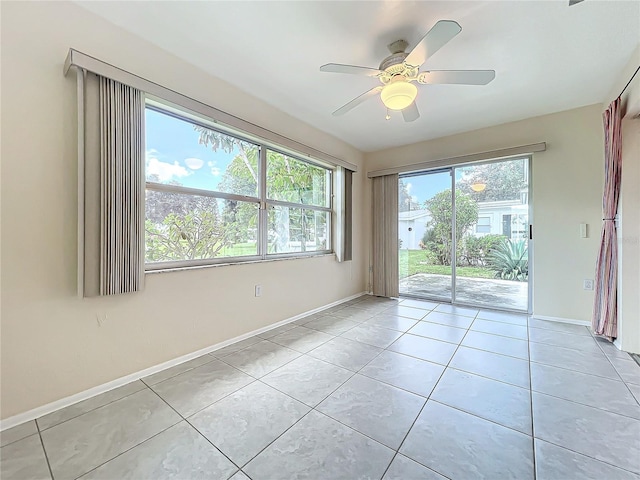 empty room featuring ceiling fan, baseboards, and light tile patterned floors