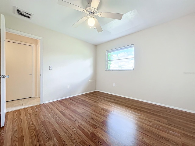 empty room featuring ceiling fan and wood-type flooring