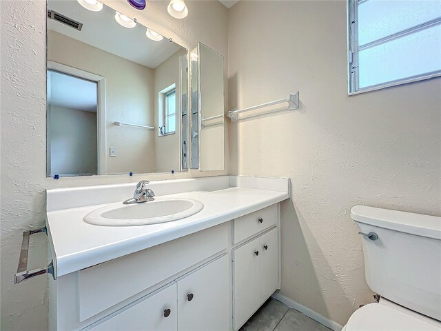 bathroom featuring visible vents, tile patterned flooring, vanity, and toilet