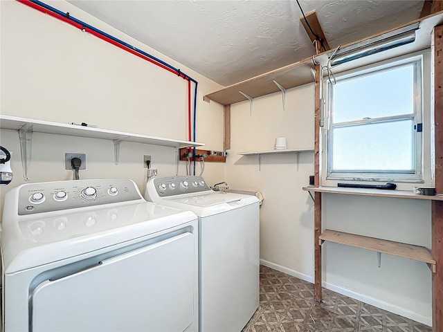 laundry room featuring baseboards, washer and clothes dryer, and laundry area