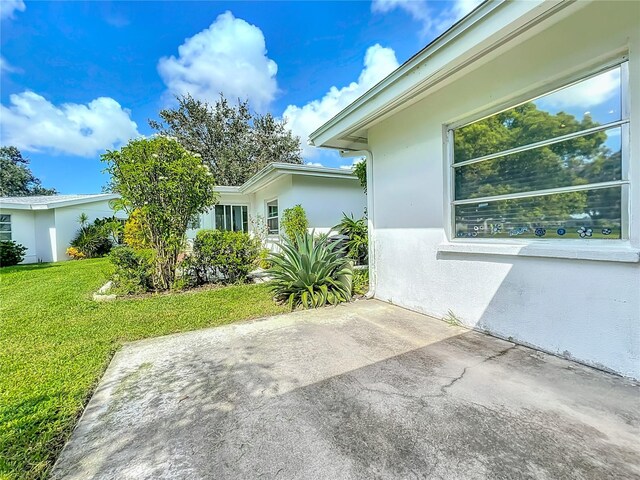 view of side of property with a lawn