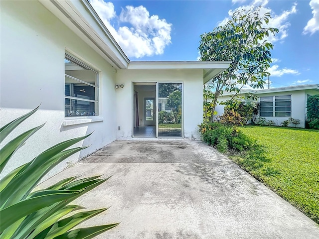 entrance to property featuring a yard