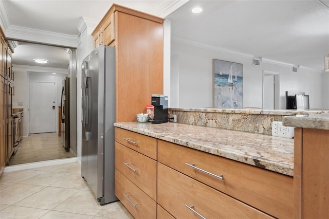 kitchen with visible vents, light stone counters, crown molding, and freestanding refrigerator