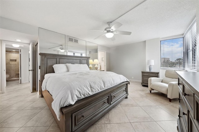 bedroom featuring light tile patterned floors, a textured ceiling, visible vents, and a ceiling fan