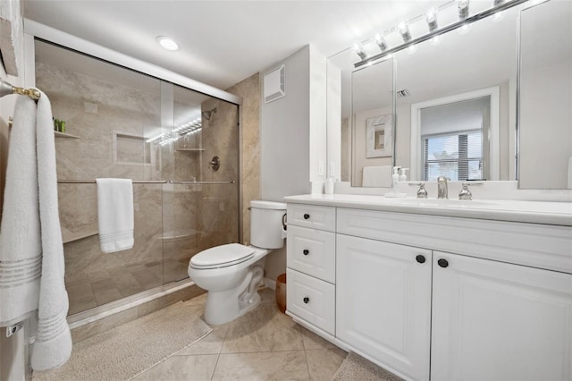 bathroom featuring visible vents, a stall shower, vanity, and toilet