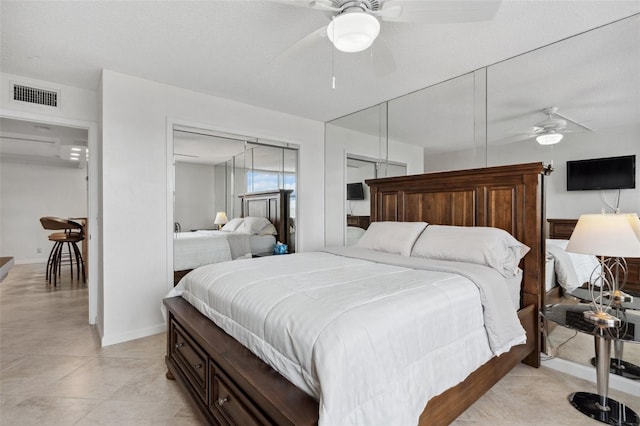 bedroom with a closet, visible vents, ceiling fan, a textured ceiling, and baseboards