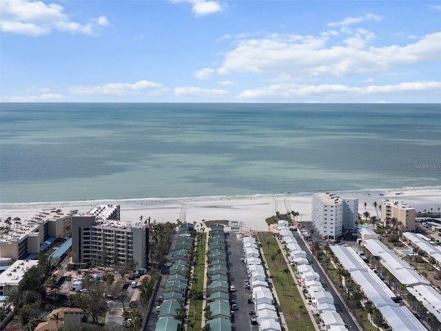 aerial view featuring a view of the beach, a water view, and a view of city