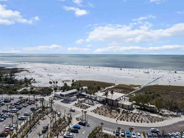 drone / aerial view featuring a view of the beach and a water view