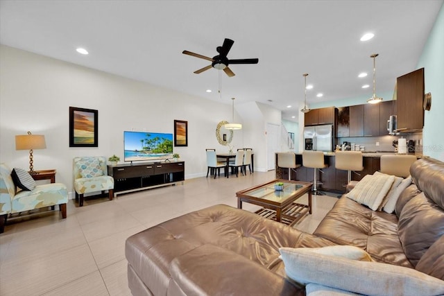 living room featuring light tile patterned floors and ceiling fan