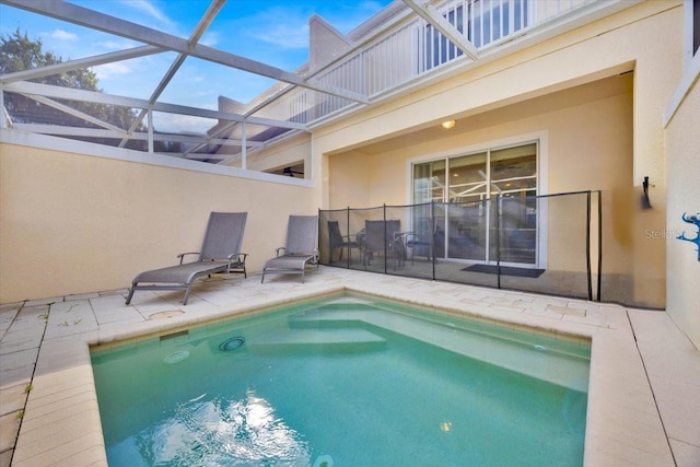 view of swimming pool with a lanai and a patio area