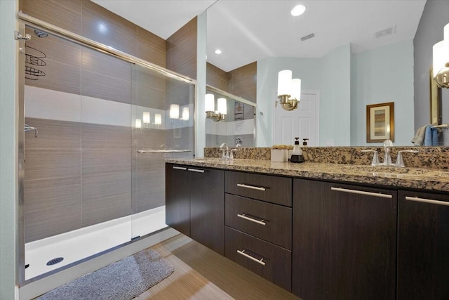 bathroom with vanity and a shower with door