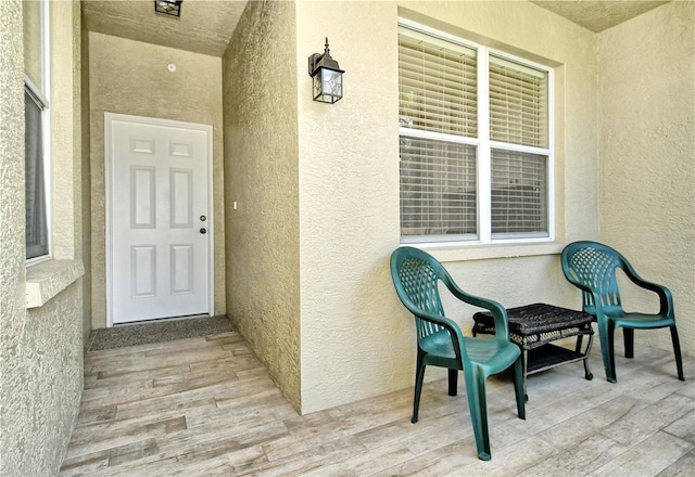 view of exterior entry featuring stucco siding