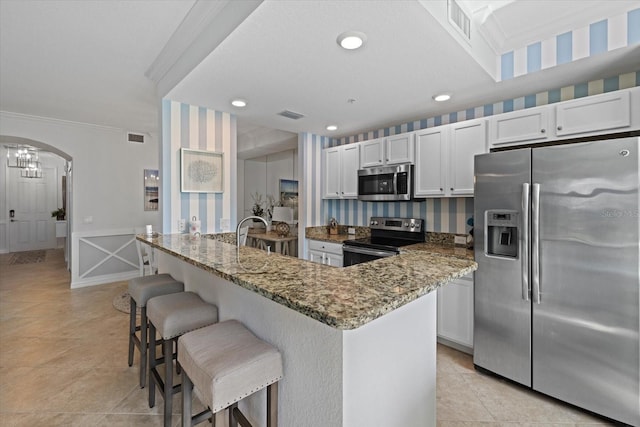 kitchen featuring appliances with stainless steel finishes, a center island, and white cabinetry