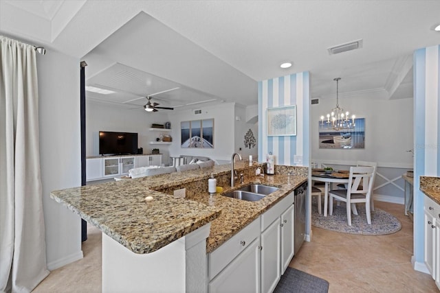 kitchen with ceiling fan with notable chandelier, sink, an island with sink, decorative light fixtures, and white cabinetry