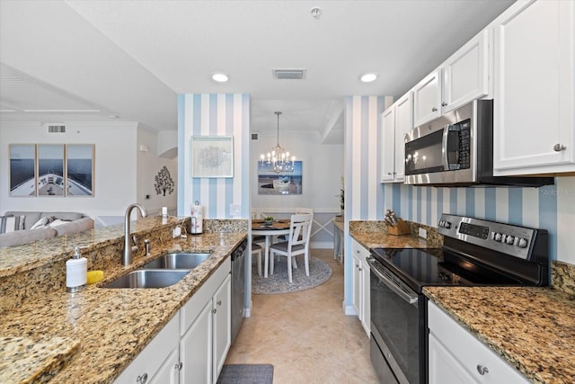 kitchen featuring appliances with stainless steel finishes, light stone counters, ornamental molding, sink, and white cabinets